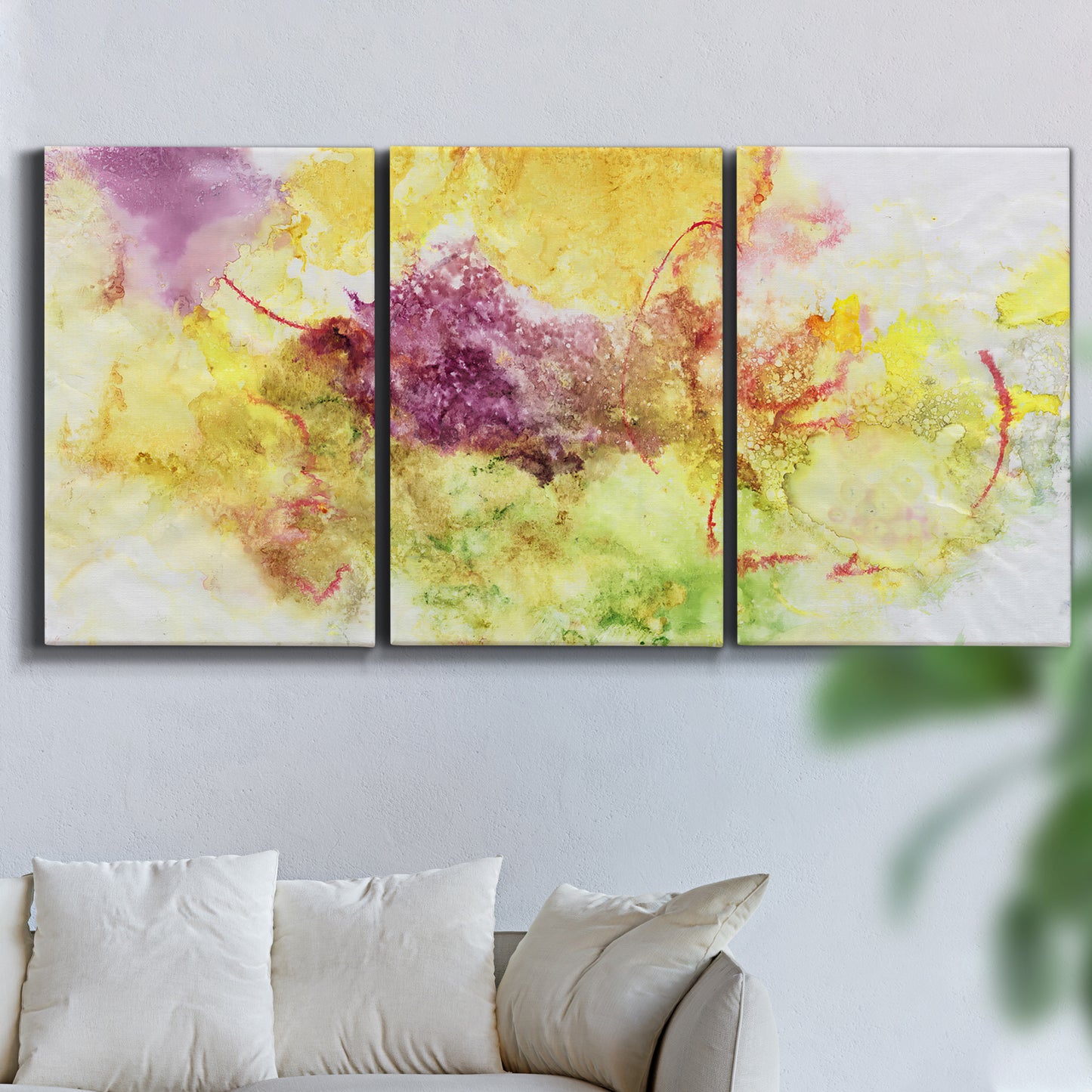 Three-panel canvas wall art featuring abstract floral rhythm composition, displayed in a living room above a sofa.