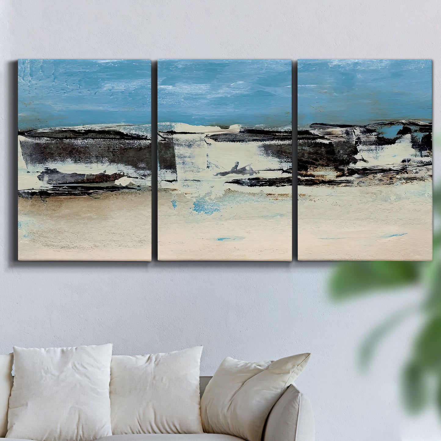 Three-panel canvas wall art featuring abstract bridge landscape in cyan, displayed in a living room above a sofa.