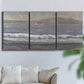 Three-panel canvas wall art featuring shoreline between land and sea, displayed in a living room above a sofa.