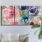 Three-panel canvas wall art featuring soft floral watercolor composition, displayed in a living room above a sofa.