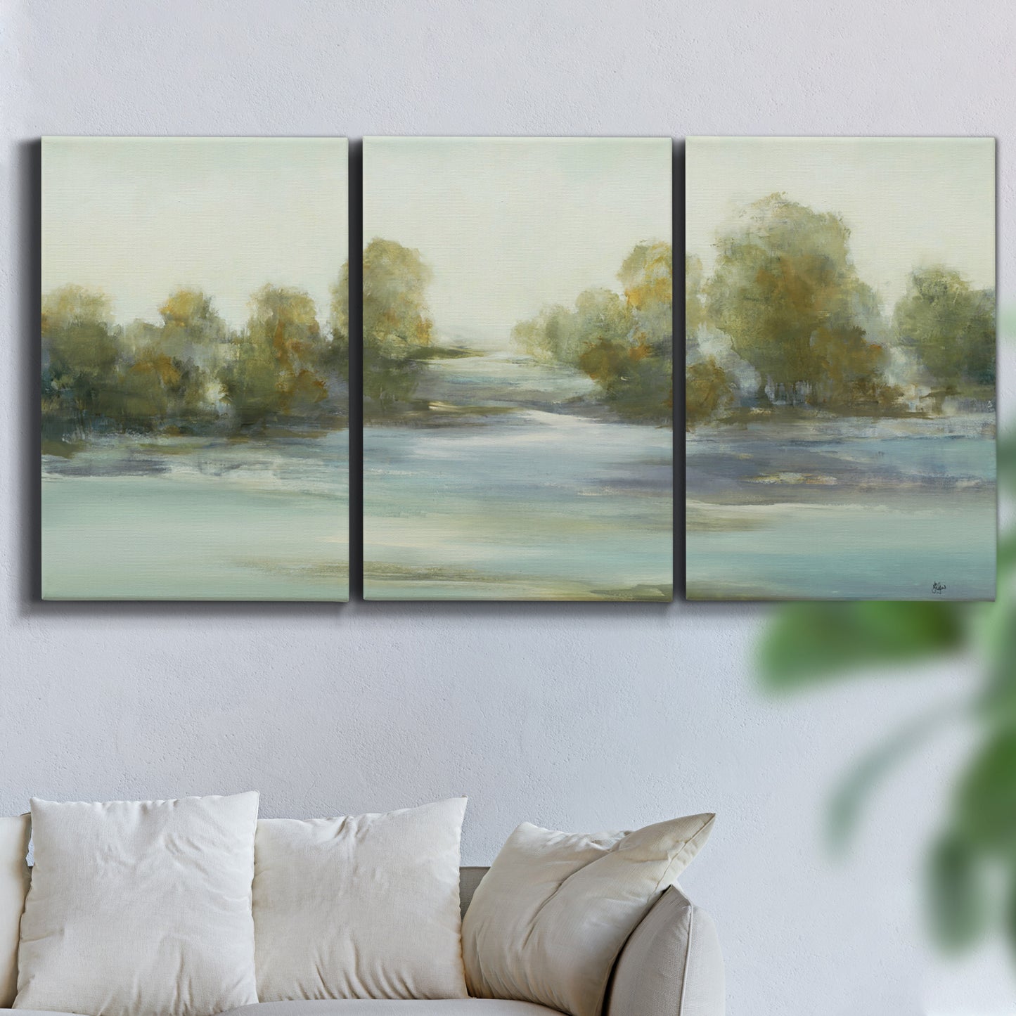 Three-panel canvas wall art featuring calming scenic landscape view, displayed in a living room above a sofa.