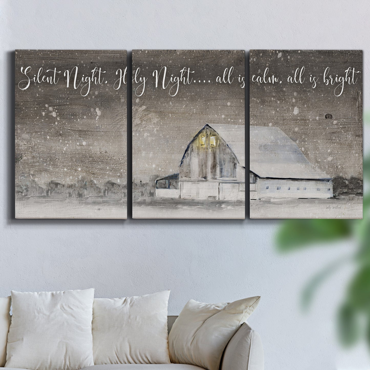 Three-panel canvas wall art featuring rustic winter holiday text art, displayed in a living room above a sofa.