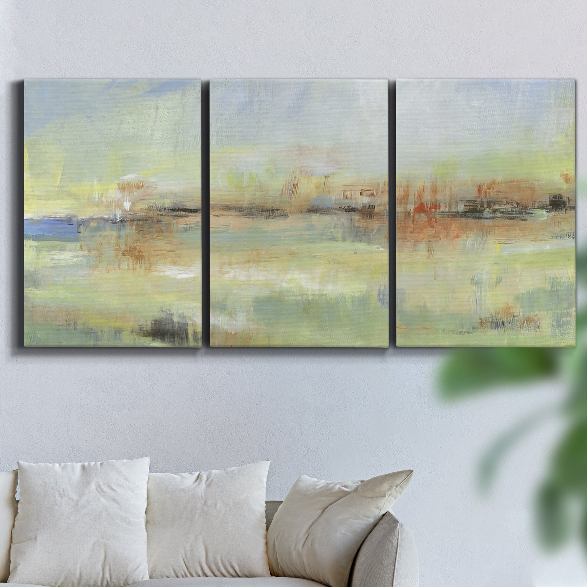 Three-panel canvas wall art featuring layered abstract transitional textures, displayed in a living room above a sofa.