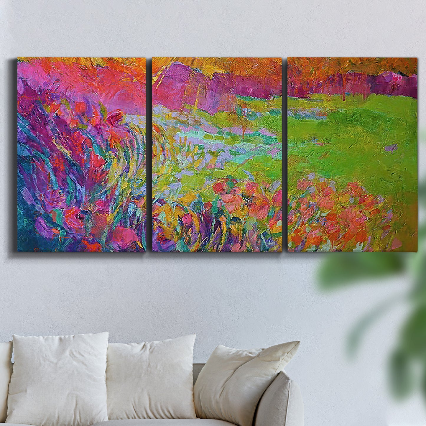Three-panel canvas wall art featuring abstract meadow inspired color fields, displayed in a living room above a sofa.