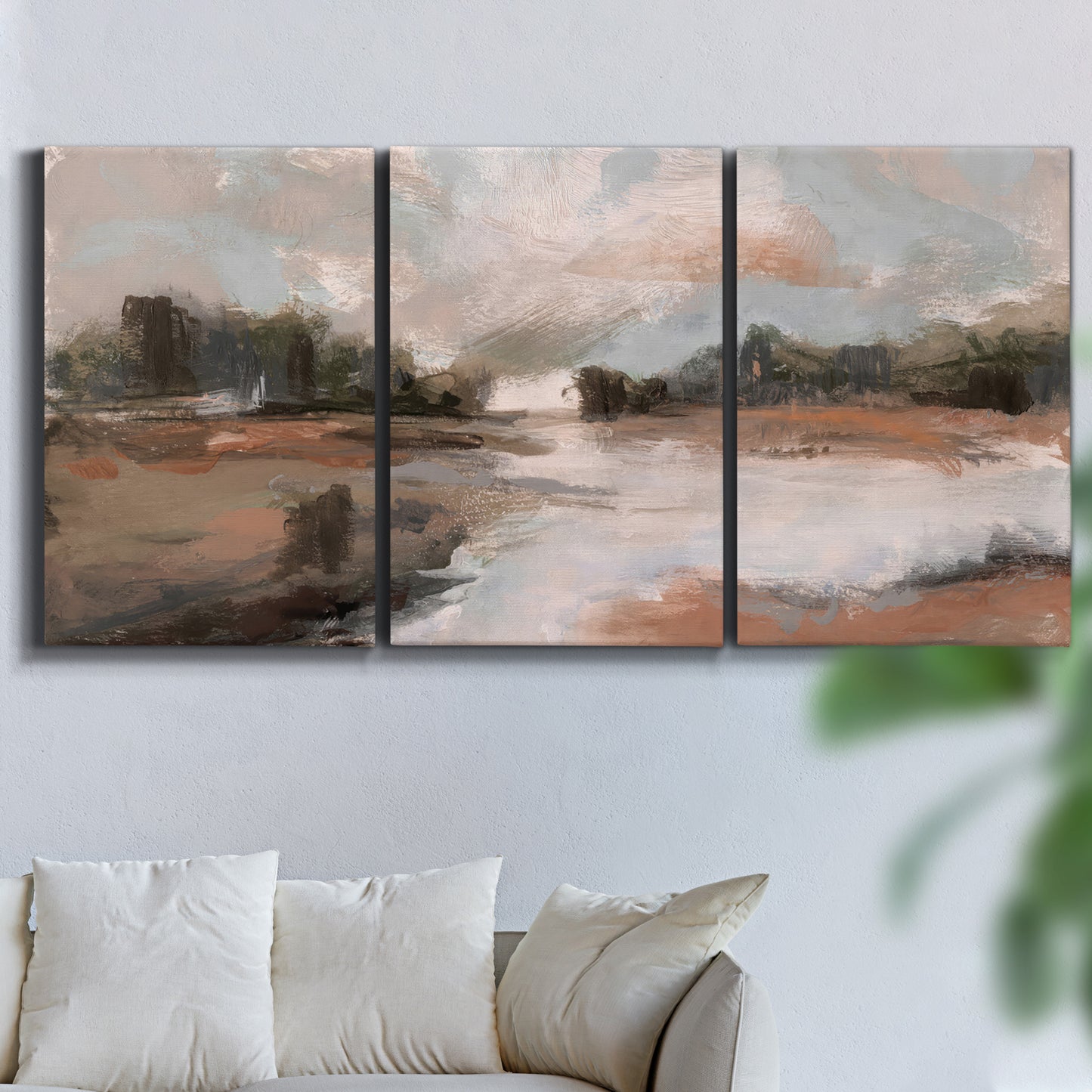 Three-panel canvas wall art featuring quiet pond with soft reflections, displayed in a living room above a sofa.