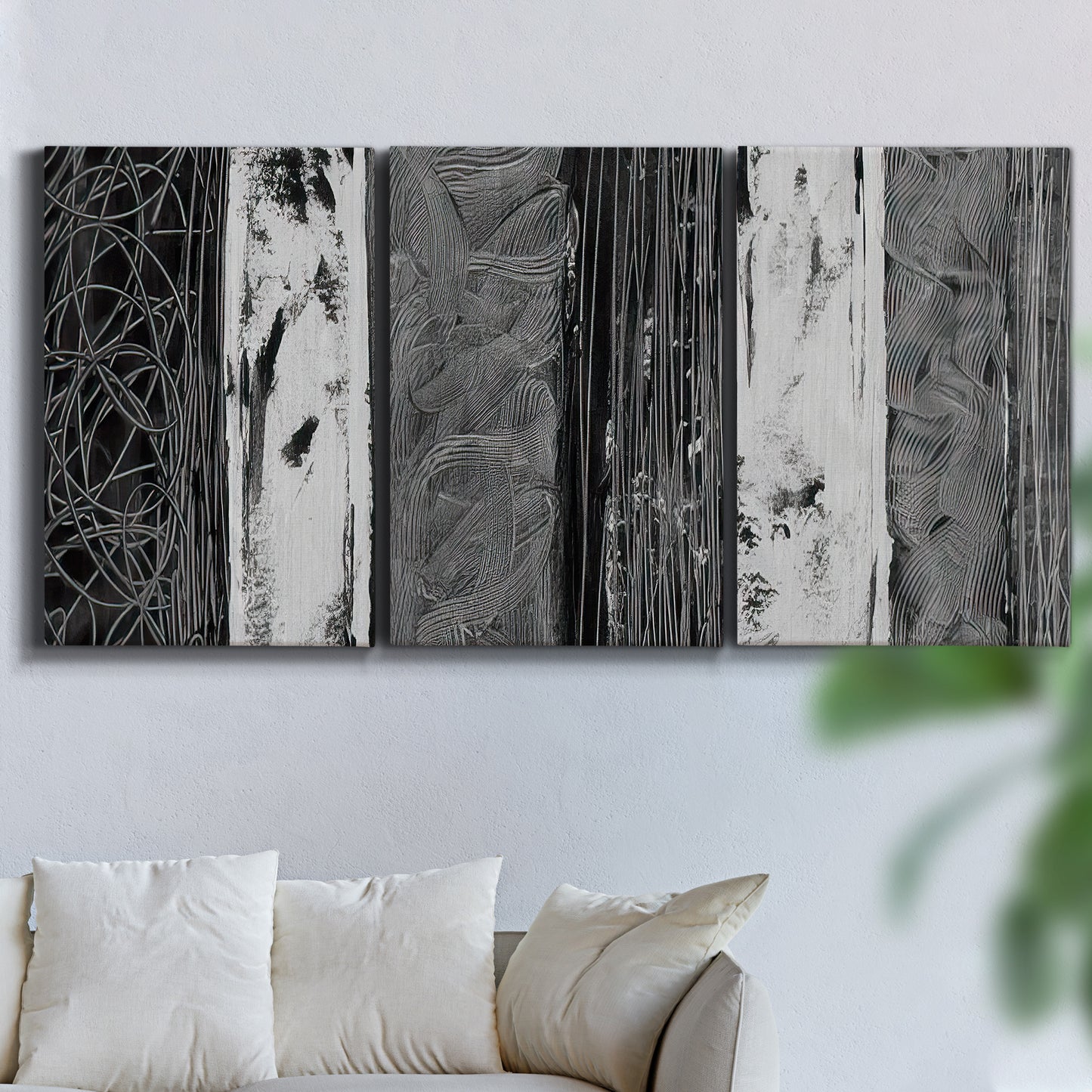 Three-panel canvas wall art featuring brushed metallic abstract textures, displayed in a living room above a sofa.