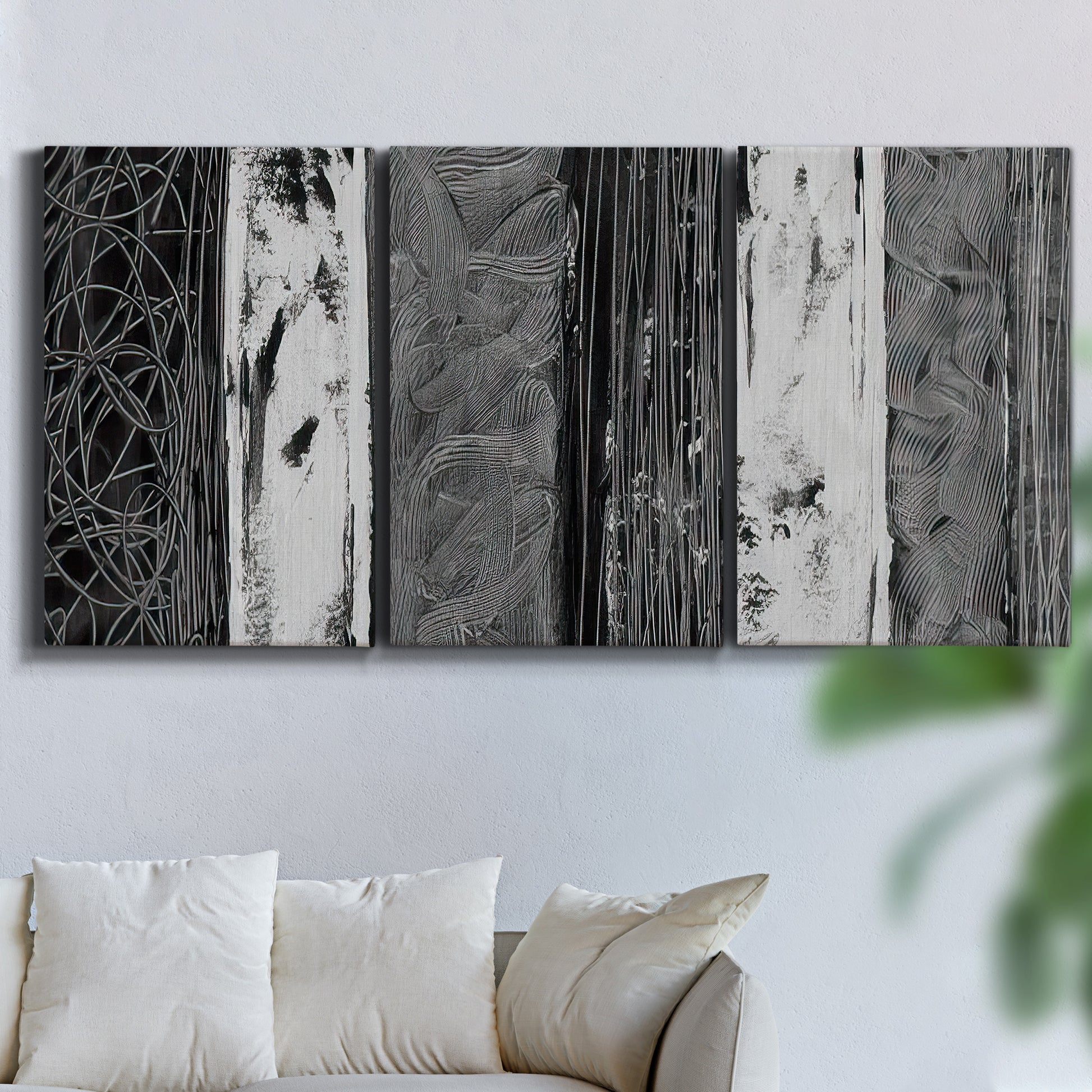 Three-panel canvas wall art featuring brushed metallic abstract textures, displayed in a living room above a sofa.