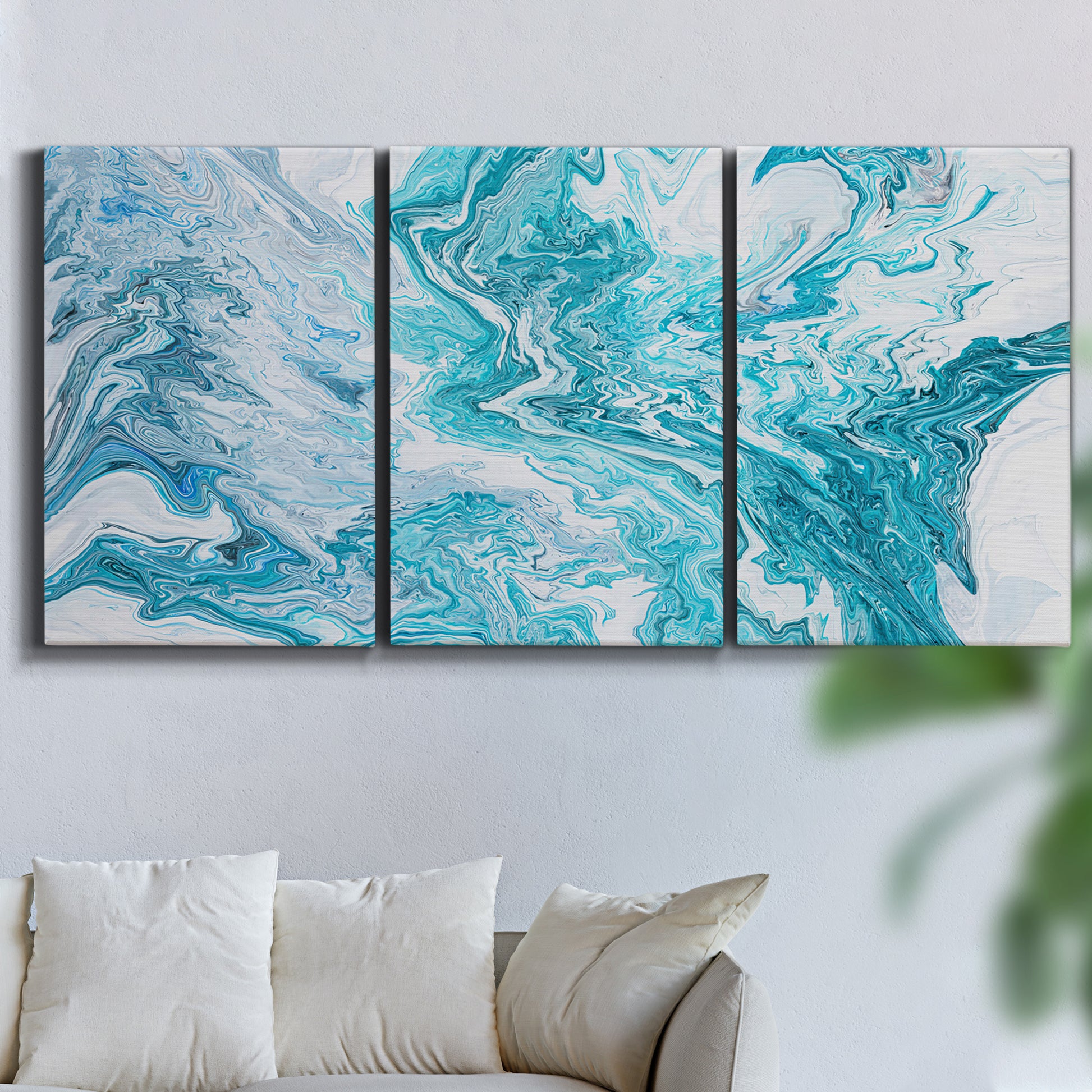 Three-panel canvas wall art featuring rocky coastal tide pool scene, displayed in a living room above a sofa.