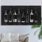 Three-panel canvas wall art featuring illustrated wine bottle cellar diagram, displayed in a living room above a sofa.