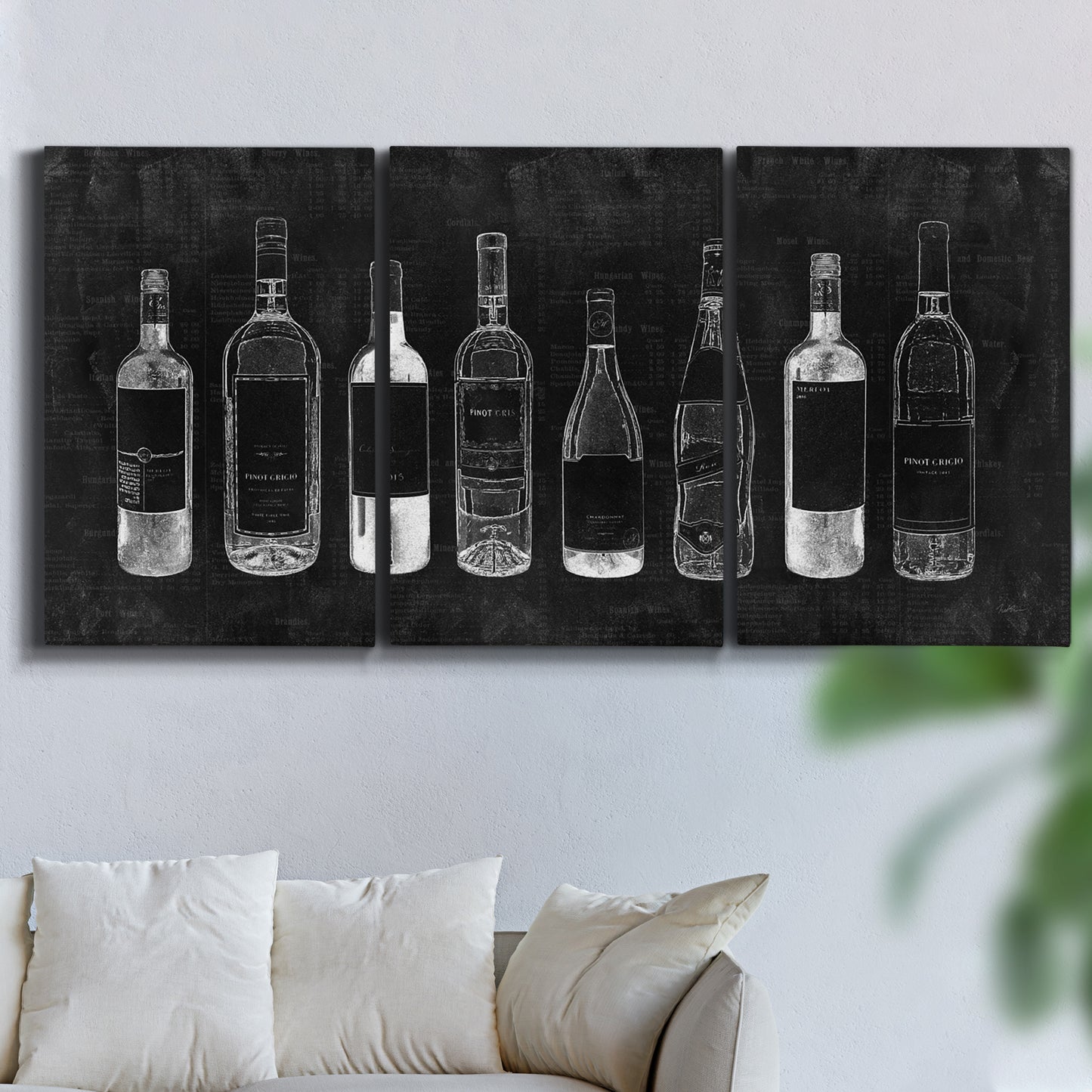 Three-panel canvas wall art featuring illustrated wine bottle cellar diagram, displayed in a living room above a sofa.