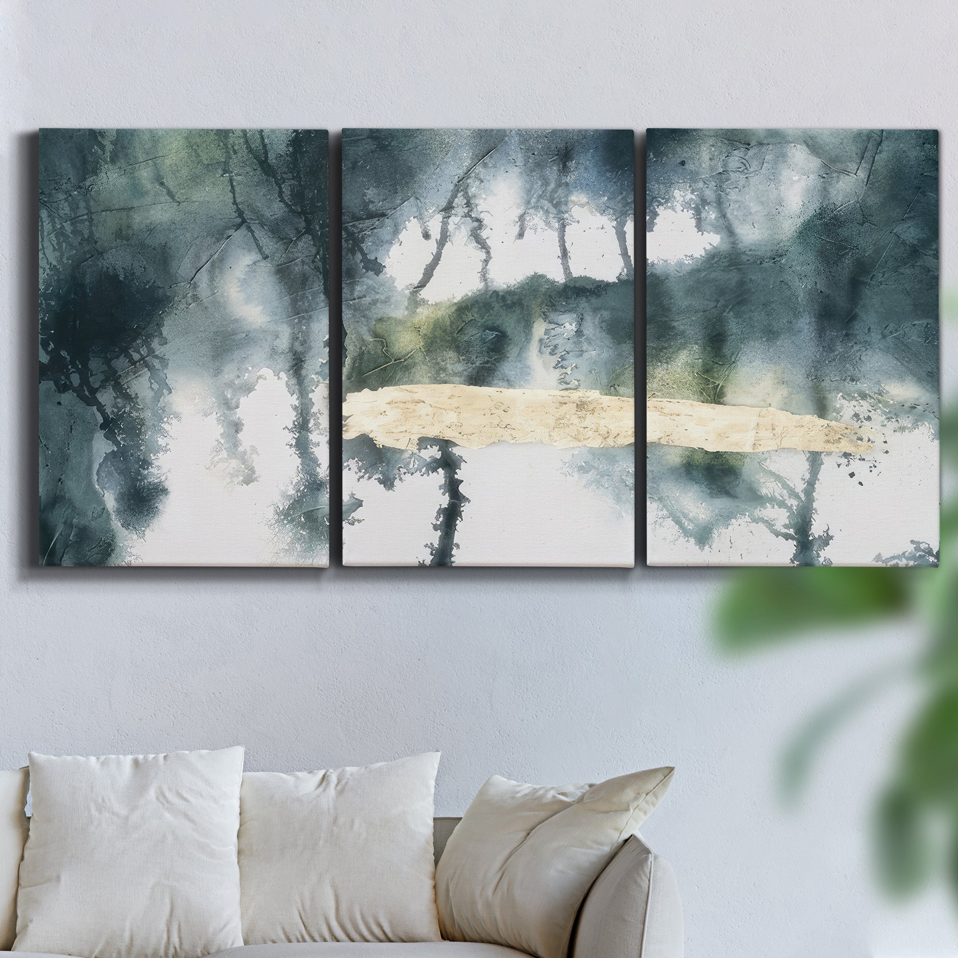 Three-panel canvas wall art featuring saturated abstract color fields, displayed in a living room above a sofa.