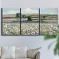Three-panel canvas wall art featuring vintage poppy filled valley, displayed in a living room above a sofa.