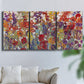Three-panel canvas wall art featuring colorful floral arrangement, displayed in a living room above a sofa.