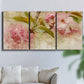 Three-panel canvas wall art featuring soft floral blossom composition, displayed in a living room above a sofa.