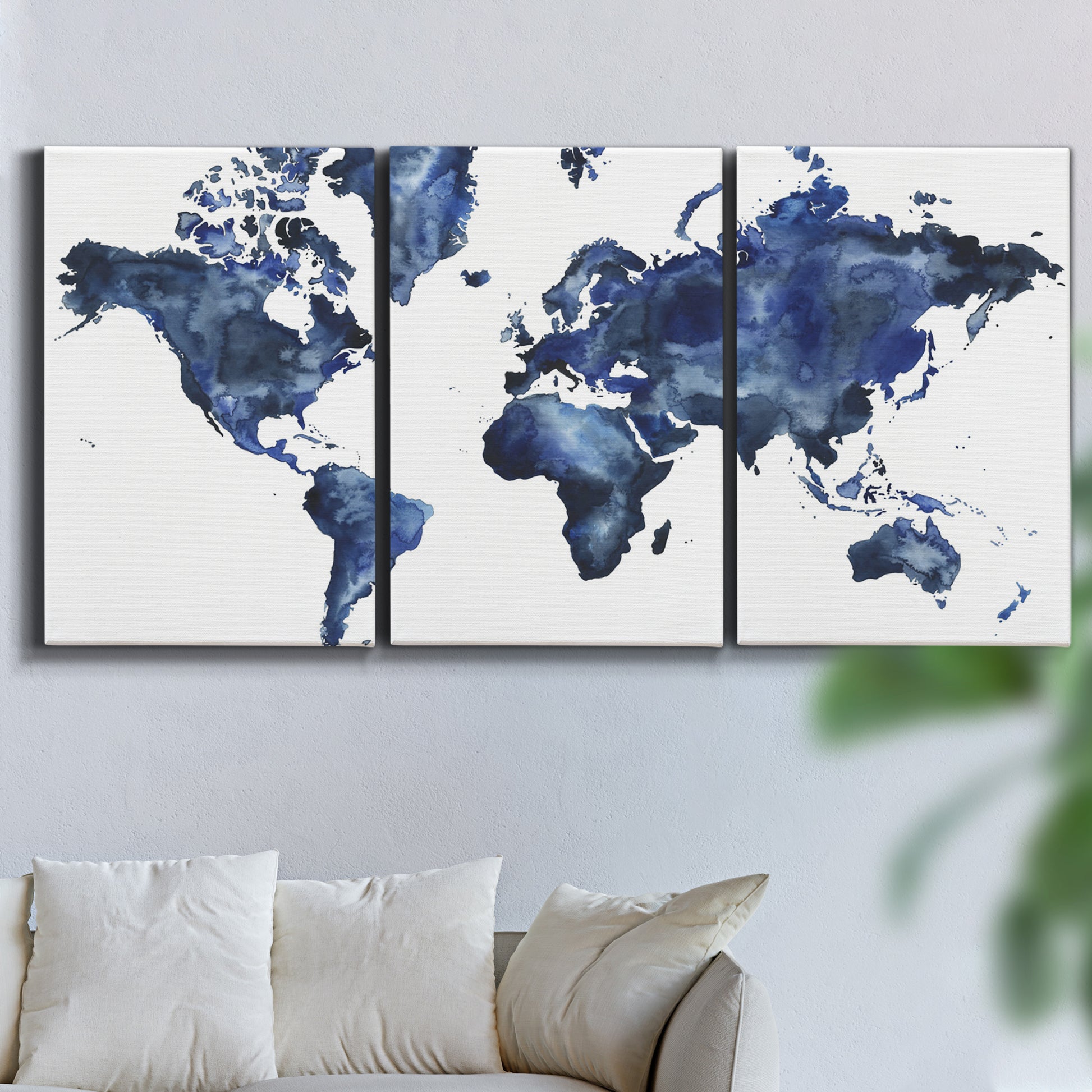 Three-panel canvas wall art featuring world map with water motif, displayed in a living room above a sofa.