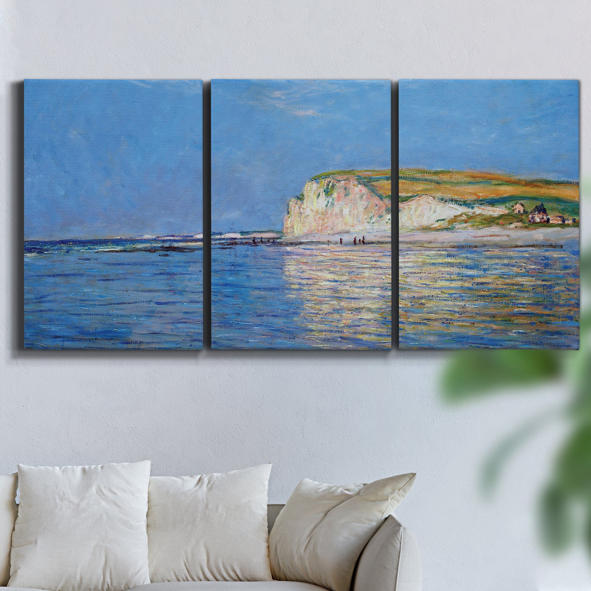 Three-panel canvas wall art featuring white cliffs rising above sea, displayed in a living room above a sofa.