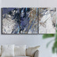 Three-panel canvas wall art featuring textured blue abstract composition, displayed in a living room above a sofa.