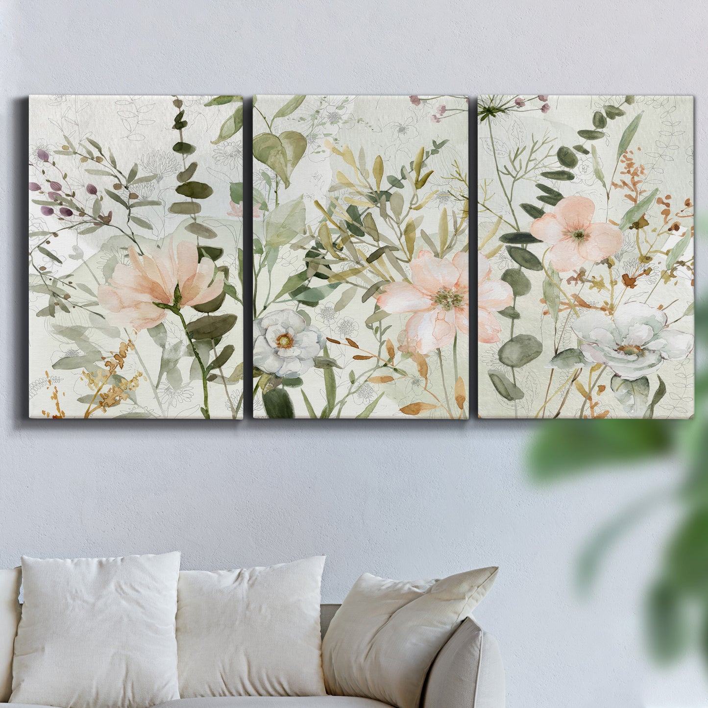 Three-panel canvas wall art featuring vintage floral botanical sketchbook, displayed in a living room above a sofa.