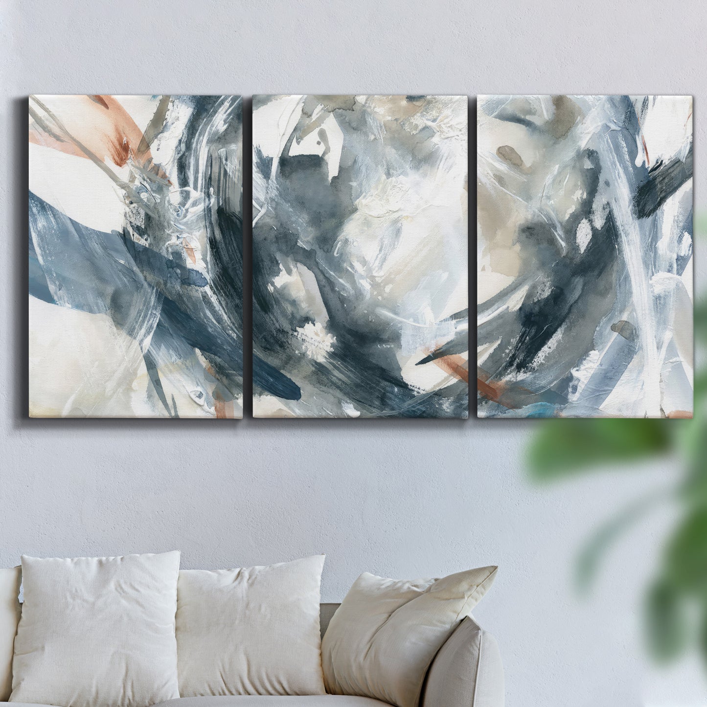 Three-panel canvas wall art featuring repeating abstract geometric array, displayed in a living room above a sofa.