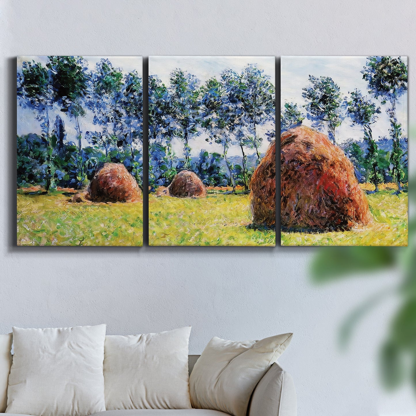Three-panel canvas wall art featuring harvested grainstacks in field, displayed in a living room above a sofa.