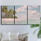 Three-panel canvas wall art featuring tropical sand dunes with palms, displayed in a living room above a sofa.