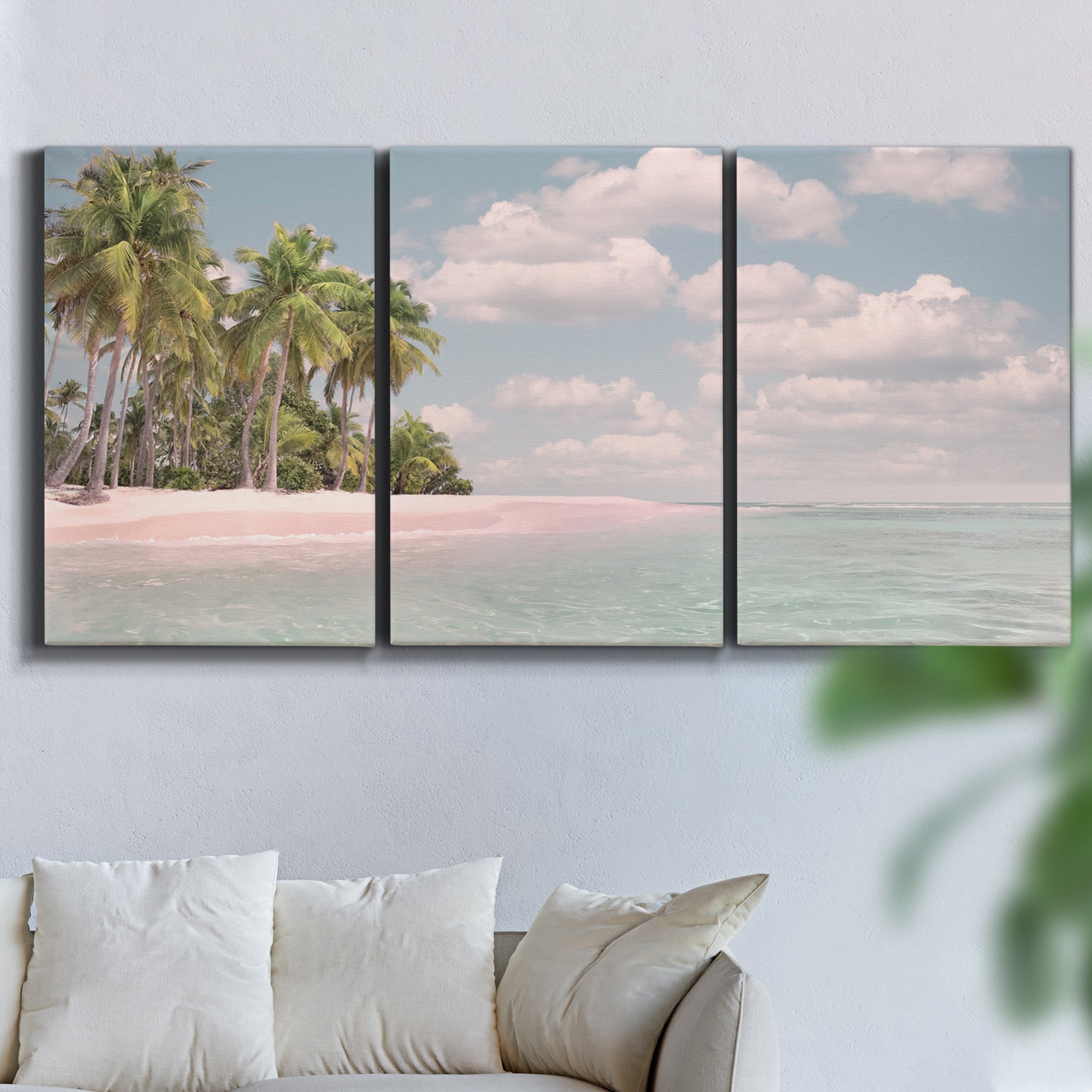 Three-panel canvas wall art featuring tropical sand dunes with palms, displayed in a living room above a sofa.