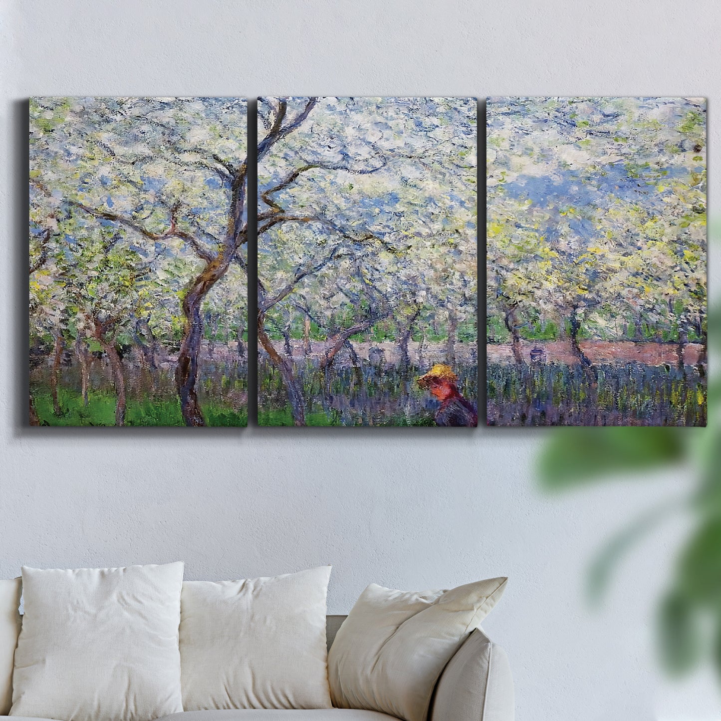 Three-panel canvas wall art featuring fresh spring countryside landscape, displayed in a living room above a sofa.