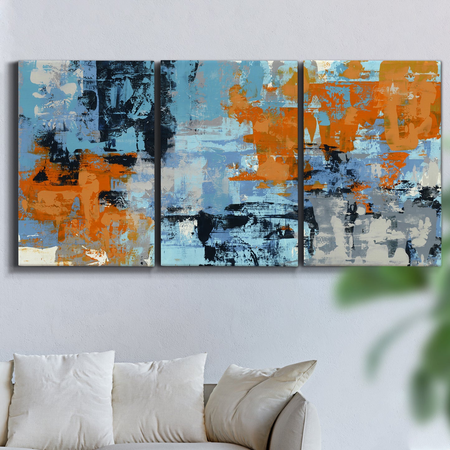Three-panel canvas wall art featuring mid century abstract playground shapes, displayed in a living room above a sofa.