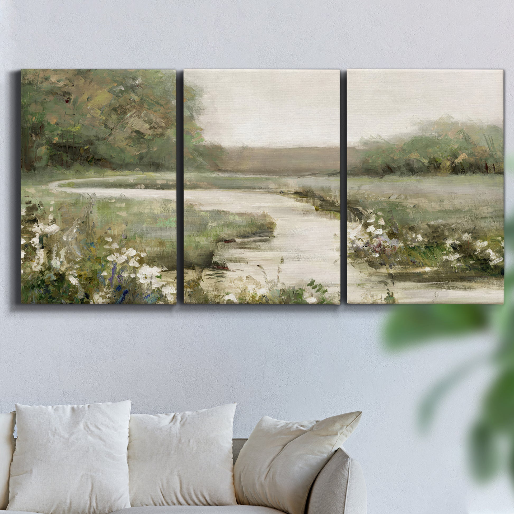 Three-panel canvas wall art featuring narrow path through quiet landscape, displayed in a living room above a sofa.