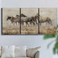 Three-panel canvas wall art featuring wild horses roaming open terrain, displayed in a living room above a sofa.