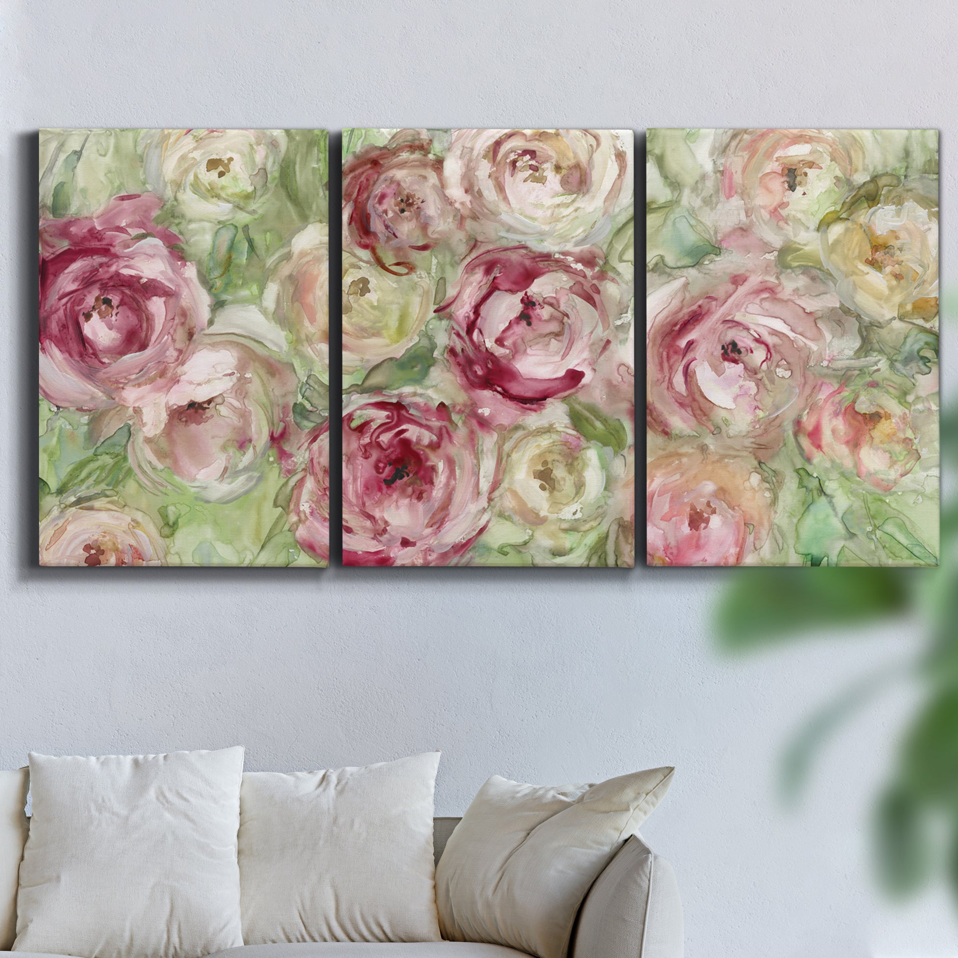 Three-panel canvas wall art featuring blooming climbing rose, displayed in a living room above a sofa.