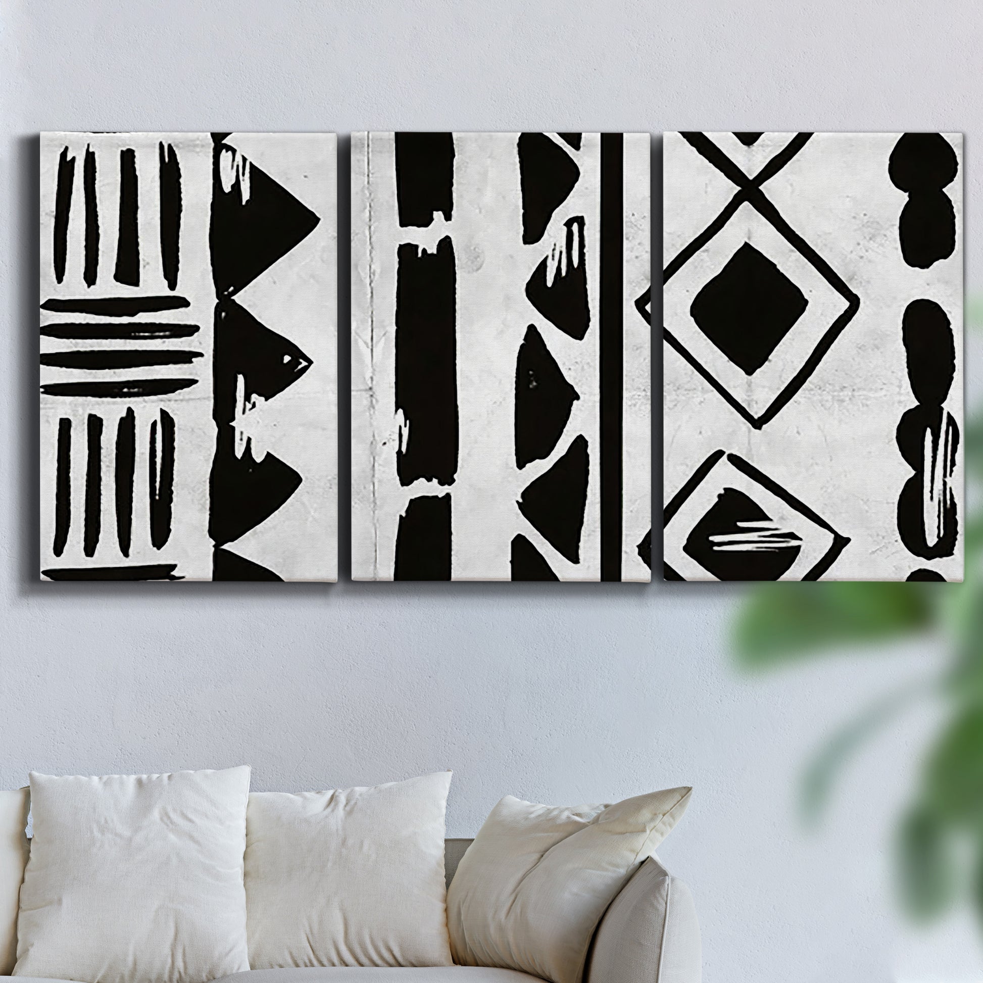Three-panel canvas wall art featuring geometric abstract forms merging pattern, displayed in a living room above a sofa.