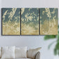 Three-panel canvas wall art featuring lupine flowers in seasonal bloom, displayed in a living room above a sofa.