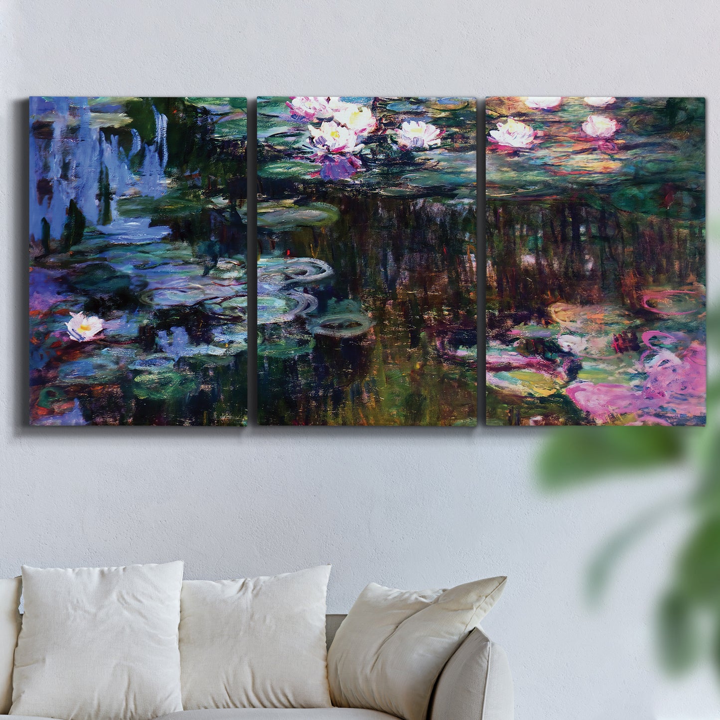 Three-panel canvas wall art featuring water lilies with willow reflections, displayed in a living room above a sofa.