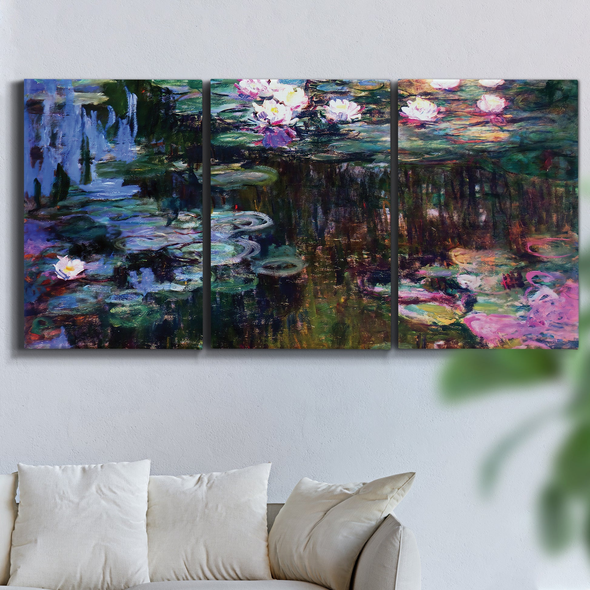 Three-panel canvas wall art featuring water lilies with willow reflections, displayed in a living room above a sofa.