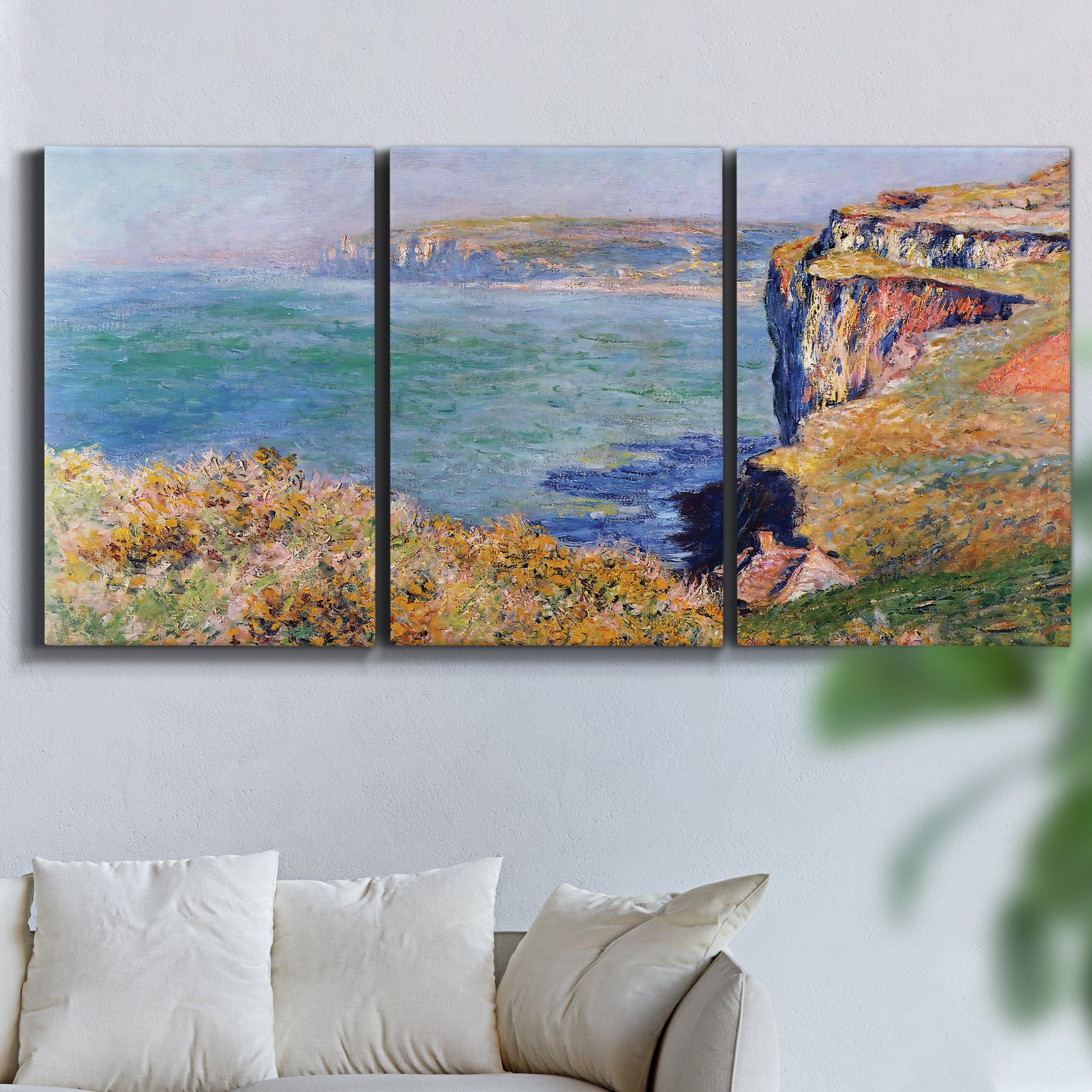 Three-panel canvas wall art featuring coastal village view near dieppe, displayed in a living room above a sofa.