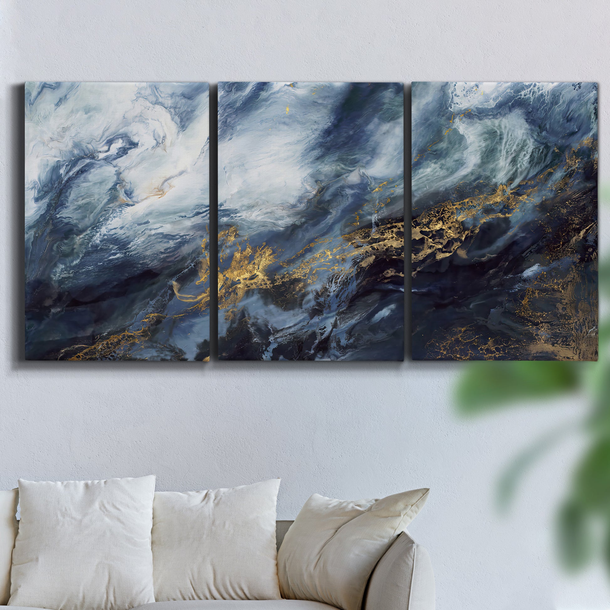 Three-panel canvas wall art featuring soft abstract landscape anticipation tones, displayed in a living room above a sofa.