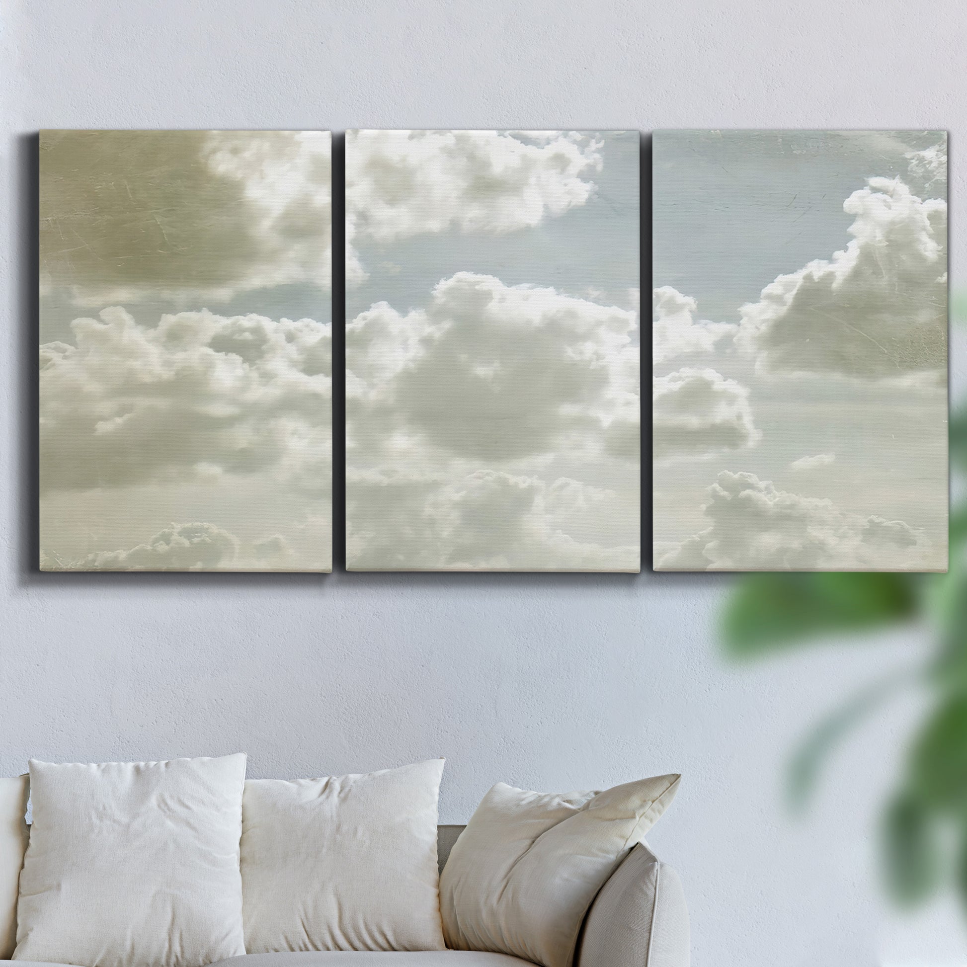 Three-panel canvas wall art featuring whimsical vertical tree landscape, displayed in a living room above a sofa.