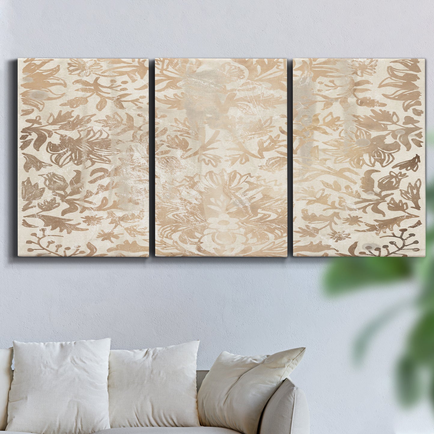 Three-panel canvas wall art featuring ornamental damask abstract pattern, displayed in a living room above a sofa.