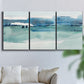 Three-panel canvas wall art featuring minimalist ultramarine abstract vista, displayed in a living room above a sofa.