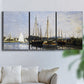 Three-panel canvas wall art featuring small pleasure boats on calm water, displayed in a living room above a sofa.
