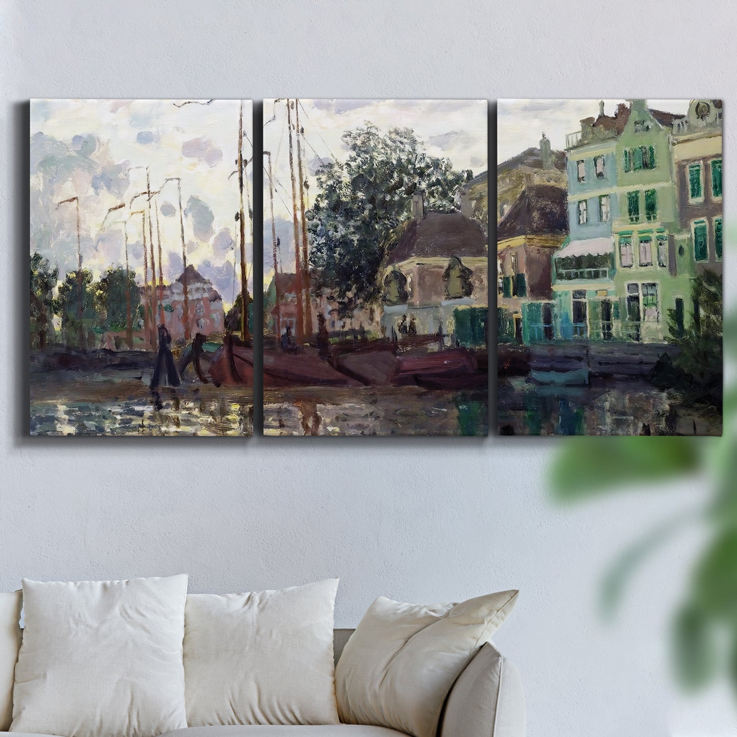 Three-panel canvas wall art featuring riverside town dike at evening, displayed in a living room above a sofa.