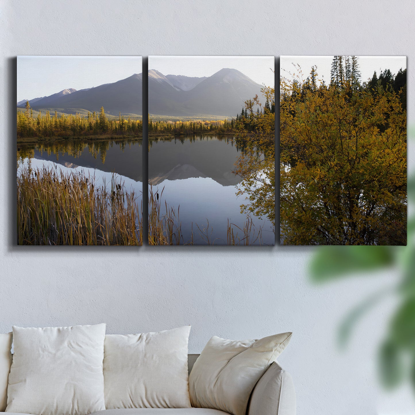 Three-panel canvas wall art featuring low light river photography, displayed in a living room above a sofa.
