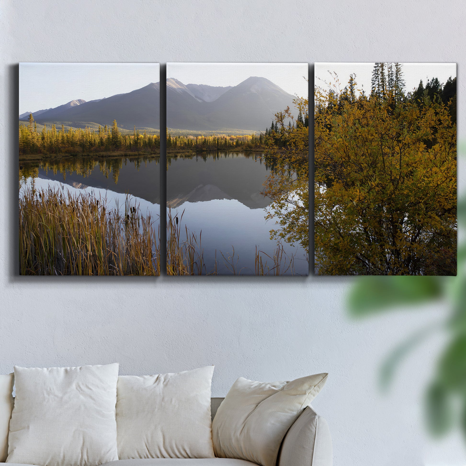 Three-panel canvas wall art featuring low light river photography, displayed in a living room above a sofa.