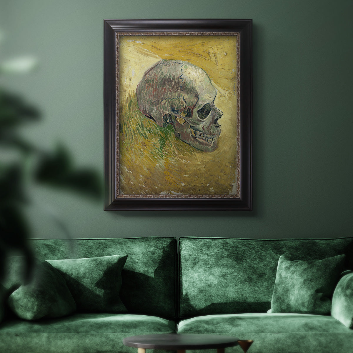 Profile skull study artwork by Vincent van Gogh in an ornate black frame with gilded inner detail displayed in a dark-toned interior setting.