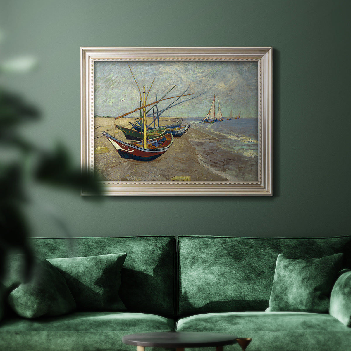 Impressionist coastal fishing boats scene by Vincent van Gogh in an ornate champagne frame displayed in a dark-toned interior setting.