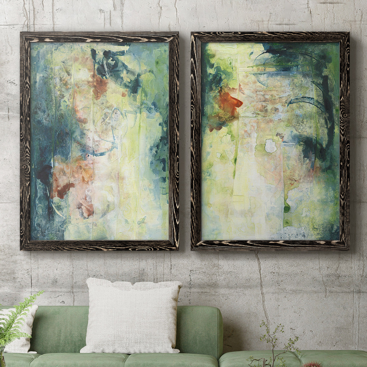 Set of two black barnwood framed canvas prints depicting a coordinated art pair of layered blue green cream and charcoal textures rendered as nature-inspired mixed-media abstracts above a sofa in a modern living room.