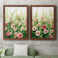 Set of two maple barnwood framed canvas prints depicting a coordinated art pair of a field of pink coral and white flowers rendered as luminous impressionistic floral paintings above a sofa in a modern living room.
