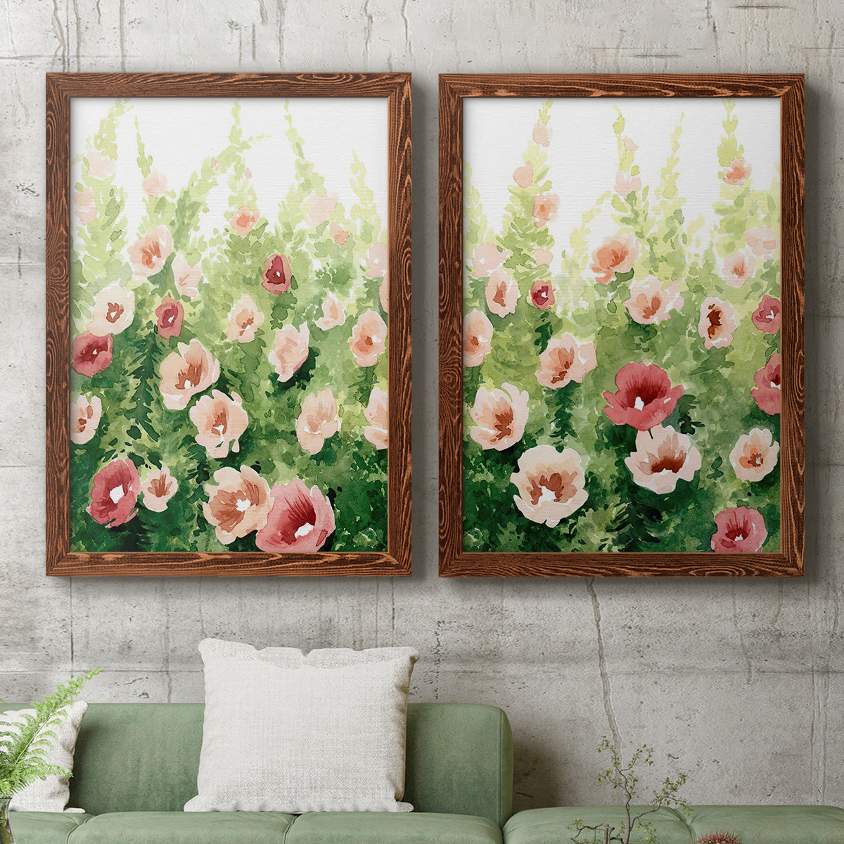 Set of two maple barnwood framed canvas prints depicting a coordinated art pair of a field of pink coral and white flowers rendered as luminous impressionistic floral paintings above a sofa in a modern living room.
