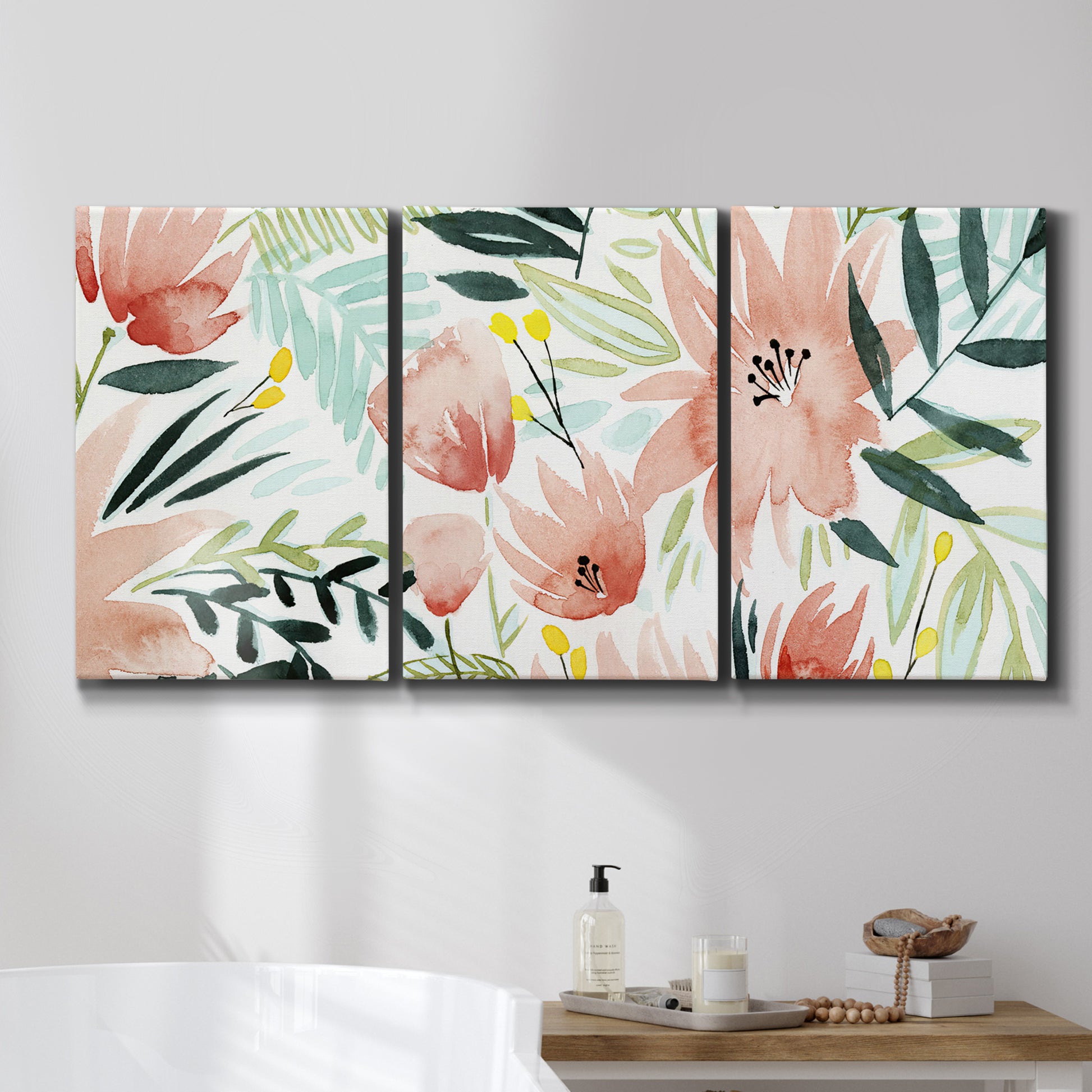 Three-panel canvas wall art featuring layered tropical plant collage, displayed in a bathroom above a bathtub.
